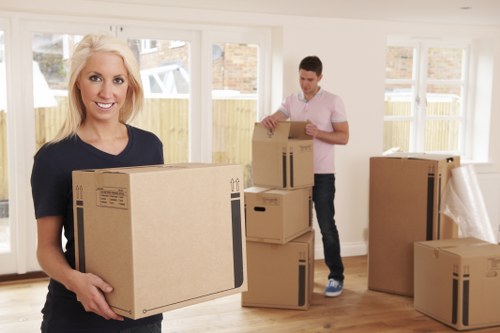 Local moving team handling furniture and boxes in a residential street