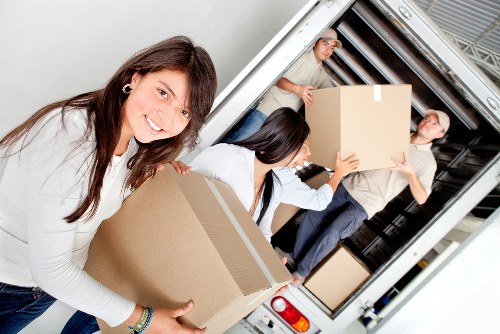 Professional movers loading items for a house or flat move