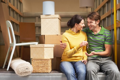 Removalists carrying furniture through a St Mary Cray property